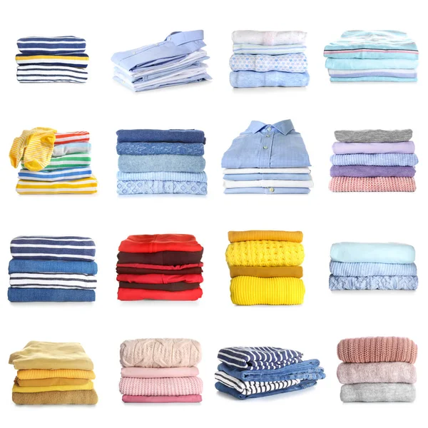 Stacks of modern different clothes on white background — 图库照片