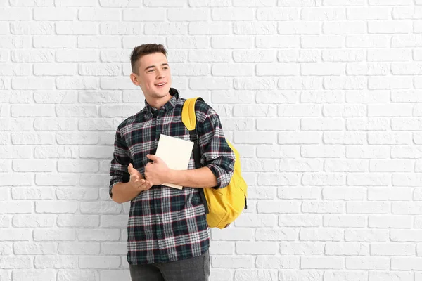 Portrait of teenage schoolboy on brick background — Stock Photo, Image