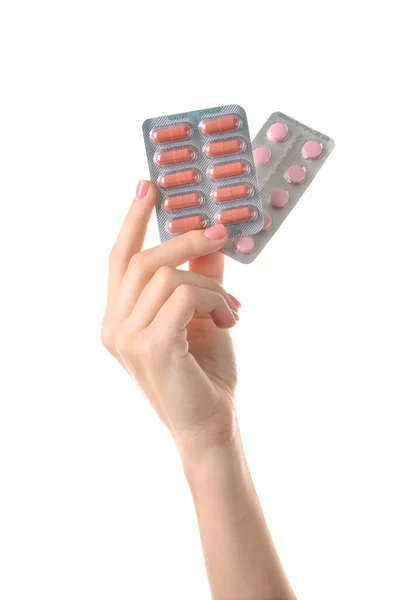 Weibliche Hand mit Pillen auf weißem Hintergrund — Stockfoto
