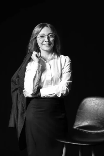 Black and white portrait of stylish businesswoman on dark background — Stock Photo, Image