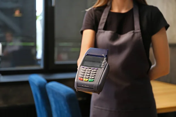 Waitress with payment terminal in restaurant, closeup — Stock Photo, Image