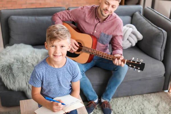 Little boy and his father with guitar at home — Stock Photo, Image