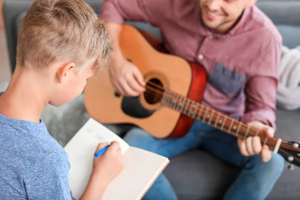 Little boy and his father with guitar at home — Stock Photo, Image