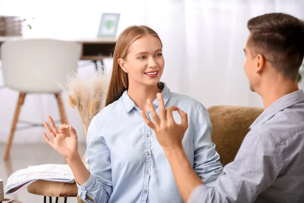 Young deaf mute couple using sign language at home — Stock Photo, Image