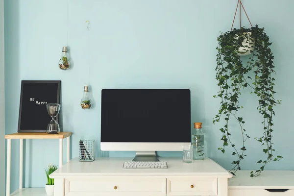 Modern stylish workplace with computer near color wall — Stock Photo, Image