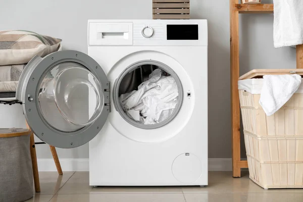 Modern washing machine with laundry in bathroom — Stock Photo, Image