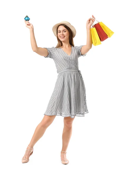 Beautiful young woman with shopping bags and credit card on white background — Stock Photo, Image