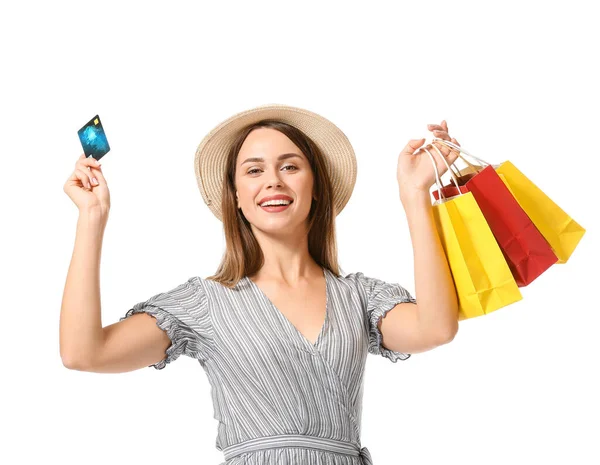 Όμορφη νεαρή γυναίκα με τσάντες ψώνια και πιστωτική κάρτα σε λευκό φόντο — Φωτογραφία Αρχείου