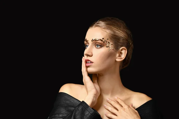 Mujer joven con cejas creativas sobre fondo oscuro — Foto de Stock