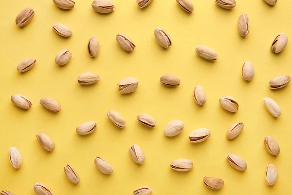 Tasty pistachio nuts on color background — Stock Photo, Image