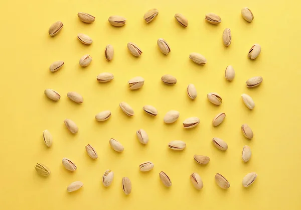 Tasty pistachio nuts on color background — Stock Photo, Image