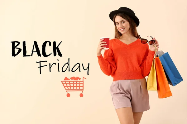 Beautiful young woman with shopping bags and text BLACK FRIDAY on color background — Stockfoto