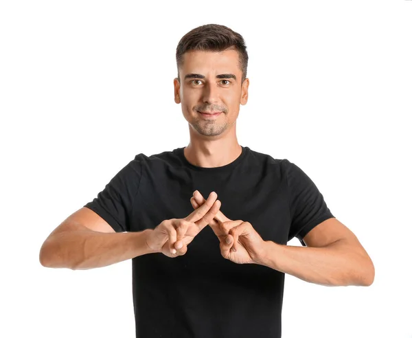 Young deaf mute man using sign language on white background — Stock Photo, Image