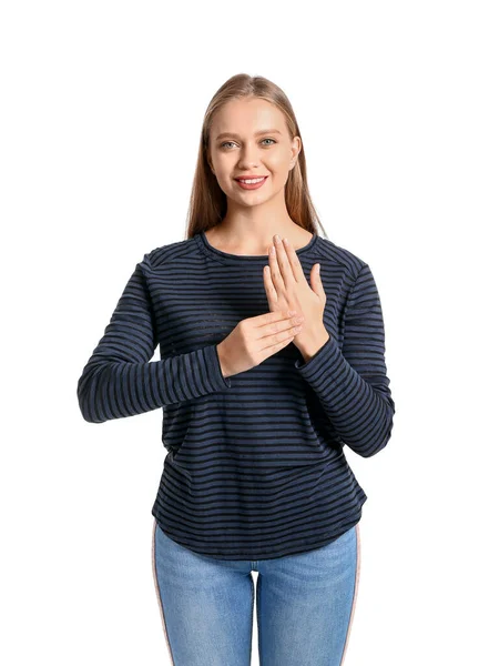 Jovem mulher surda muda usando linguagem de sinais no fundo branco — Fotografia de Stock