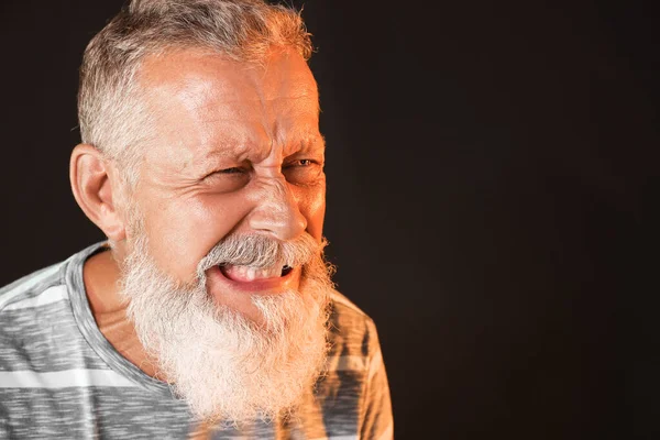 Angry mature man on dark background — Stock Photo, Image