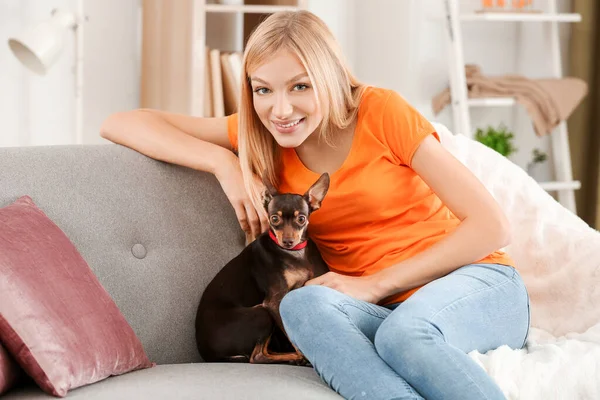Beautiful young woman with cute toy terrier dog at home — Stock Photo, Image