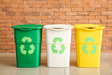 Containers for garbage near brick wall. Recycling concept