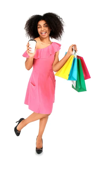 Beautiful African-American woman with shopping bags and coffee on white background — Stock Photo, Image