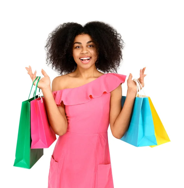 Beautiful African-American woman with shopping bags on white background — Stock Photo, Image