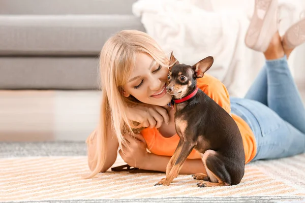 Beautiful young woman with cute toy terrier dog at home — Stock Photo, Image