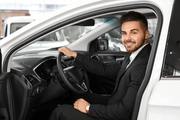 Happy male buyer sitting in new car — Stock Photo, Image