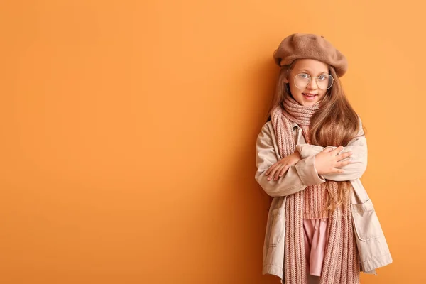 Fashionable little girl in autumn clothes on color background — Stock Photo, Image