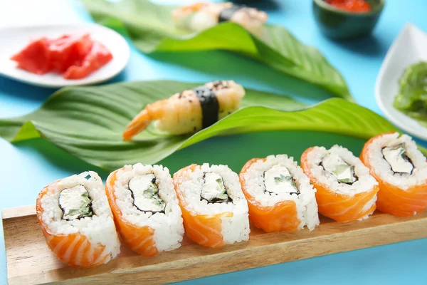 Set of tasty sushi rolls on color background — Stock Photo, Image