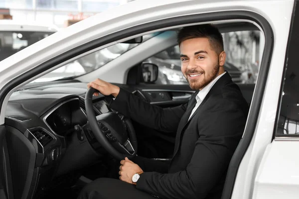 Щасливий чоловік-покупець сидить у новій машині — стокове фото