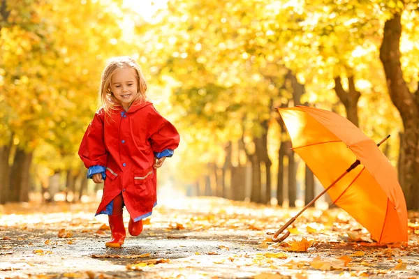 Cute little girl having fun in autumn park — Stock Photo, Image