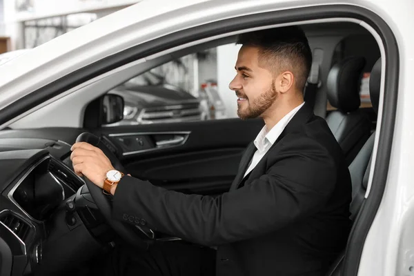 Happy male buyer sitting in new car — Stock Photo, Image