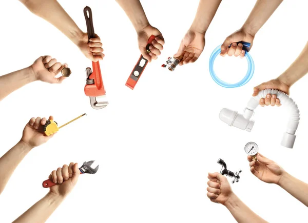 Hands with different plumber tools on white background — Stock Photo, Image