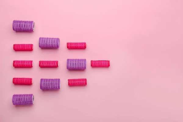 Set of hair curlers on color background — Stock Photo, Image