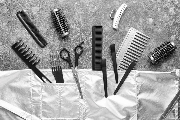 Set of hairdresser tools and accessories on grey background