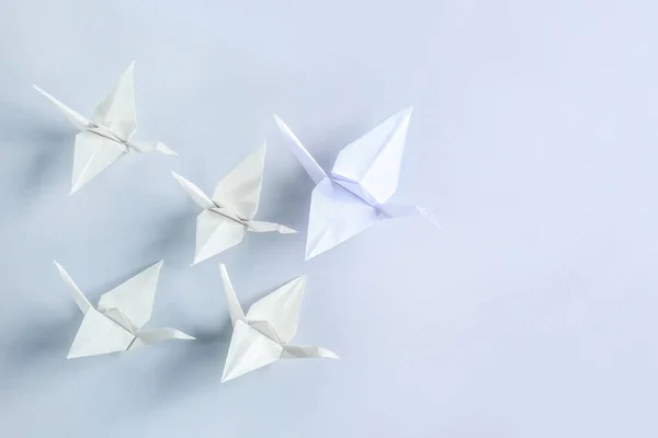 Origami cranes on light background — Stock Photo, Image