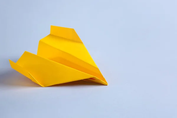 Origami airplane on light background — Stock Photo, Image
