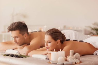 Young couple relaxing in spa salon clipart