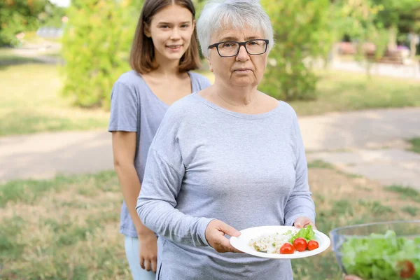 Poor people receiving food from volunteers