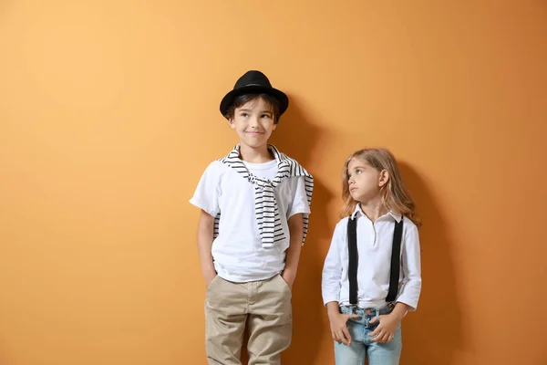 Stylish little children on color background — Stock Photo, Image