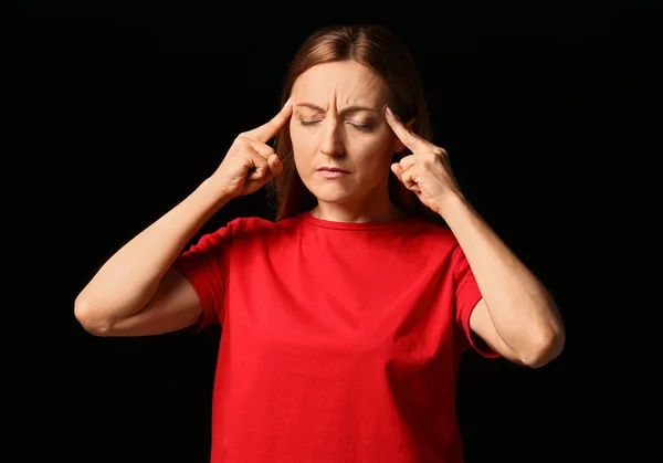 Stressed woman on dark background — Stock Photo, Image