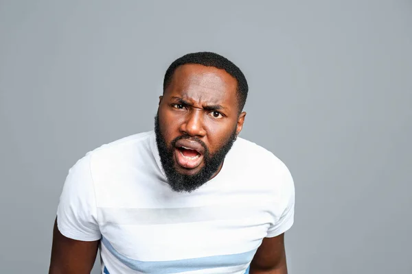 Confused African-American man on grey background — Stock Photo, Image