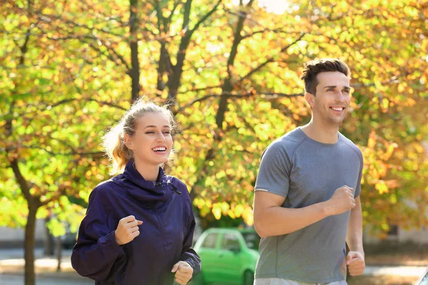 Deportiva joven pareja corriendo en parque — Foto de Stock
