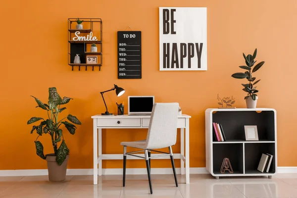 Stylish workplace with laptop near color wall — Stock Photo, Image