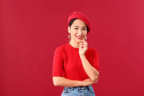 Fashionable Asian woman on color background — Stock Photo, Image