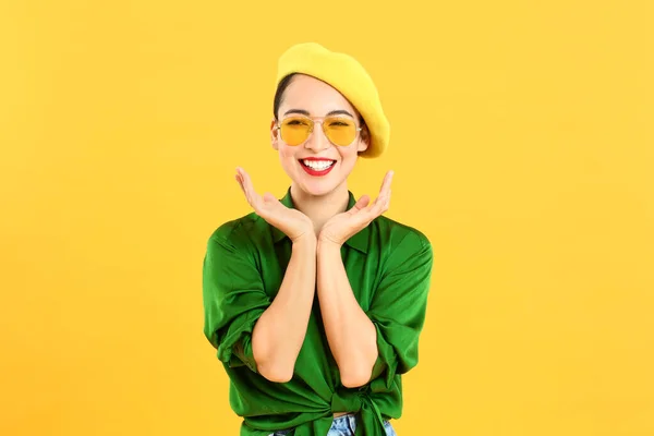 Fashionable Asian woman on color background — Stock Photo, Image