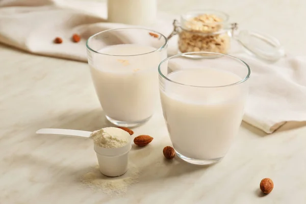 Glasses of protein shake on white table — Stock Photo, Image