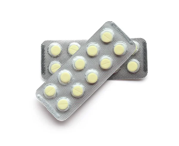 Envases de blister con pastillas sobre fondo blanco — Foto de Stock