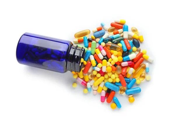 Bottle with different pills on white background — Stock Photo, Image