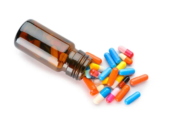Bottle with different pills on white background — Stock Photo, Image
