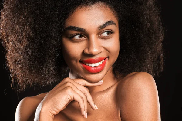 Portrait of beautiful African-American woman with bright lips on dark background