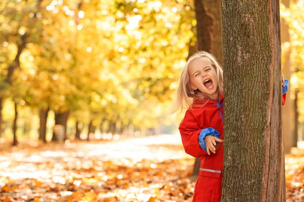 Cute little girl having fun in autumn park — Stock Photo, Image